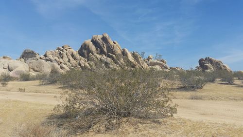 Rock formations in desert against blue sky