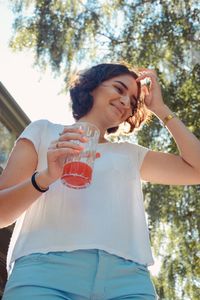 Low angle view of woman holding drink