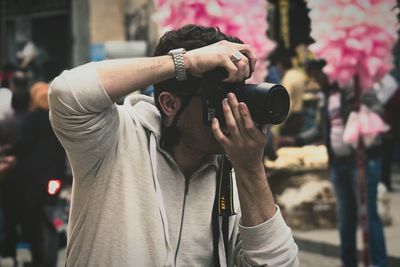Portrait of man photographing on street