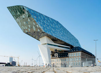 Low angle view of building against clear blue sky