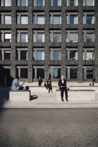 People walking on modern building in city