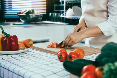 Midsection of man preparing food in kitchen