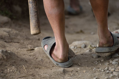 Low section of man wearing slippers