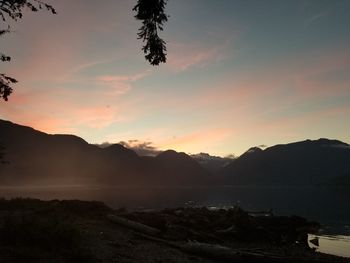 Scenic view of silhouette mountains against sky during sunset