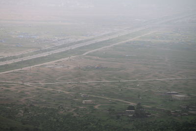 Aerial view of agricultural field against sky