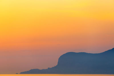 Scenic view of sea against orange sky