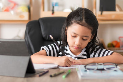 Girl sitting on table at home