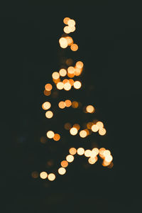Low angle view of illuminated christmas lights at night