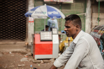 Man with umbrella in background