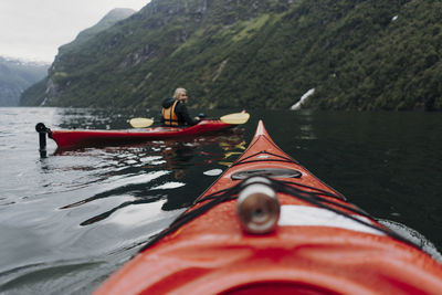 Nautical vessel on river against mountains