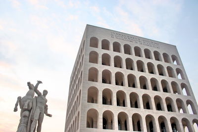 Low angle view of statue of historic building against sky