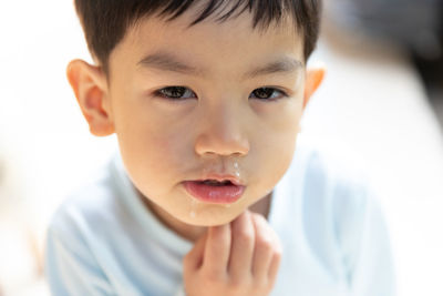 Close-up portrait of boy eating food