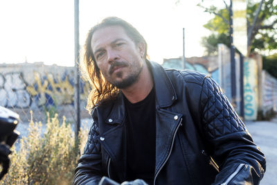 Portrait of biker sitting on bike