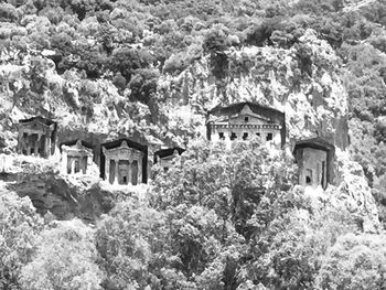 Old building by trees and mountains