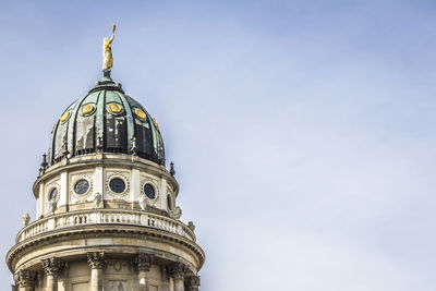 Low angle view of neue kirche against sky in city