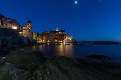 View of illuminated buildings at waterfront