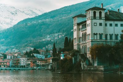 Scenic view of residential district by mountain against sky