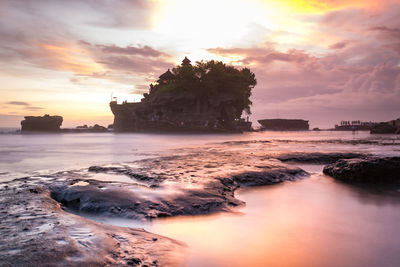 Tanah lot temple with people waiting for sunset in bali island, indonesia