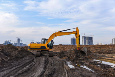 Construction site by road against sky