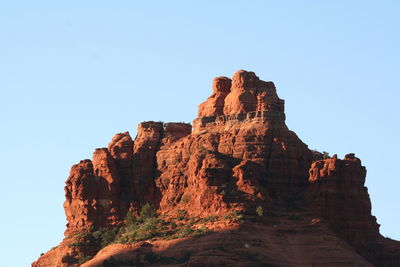 Low angle view of rock formation against clear sky