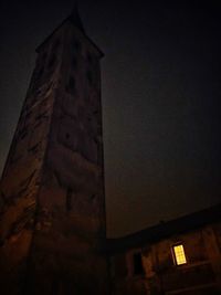 Low angle view of illuminated building against sky at night