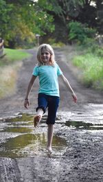 Full length of girl standing in water