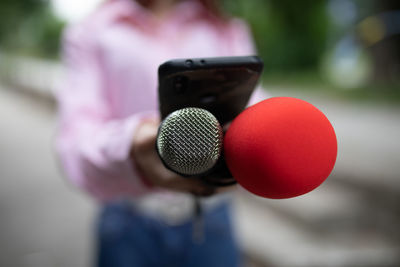 Close-up of woman holding mobile phone