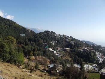 Scenic view of trees and mountains against sky