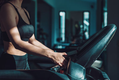 Midsection of woman exercising in gym