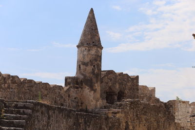 Low angle view of old ruin building against sky