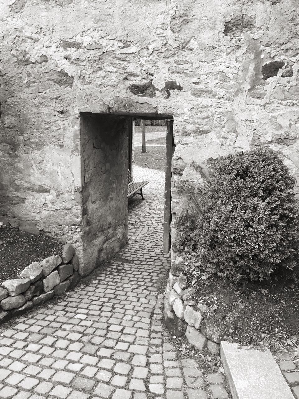 built structure, architecture, building exterior, cobblestone, paving stone, wall - building feature, stone wall, footpath, brick wall, sidewalk, sunlight, wall, day, outdoors, street, shadow, house, pavement, walkway, no people