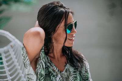 Portrait of young woman looking away outdoors