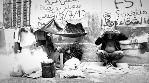 Rear view of woman sitting in city