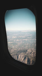 Aerial view of landscape seen through airplane window