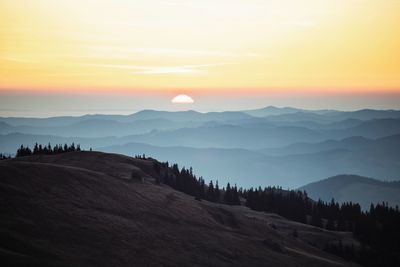 Scenic view of mountains against sky during sunset