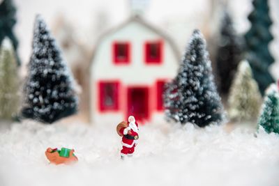 Close-up of stuffed toy on christmas tree in snow