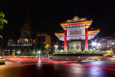 Light trails on illuminated building at night