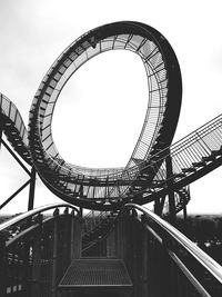 Low angle view of ferris wheel against sky