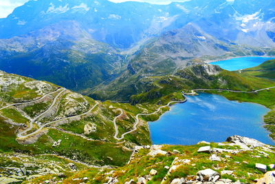 Scenic view of lake and mountains against blue sky