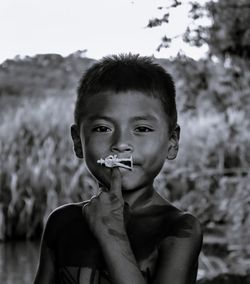 Portrait of boy holding camera