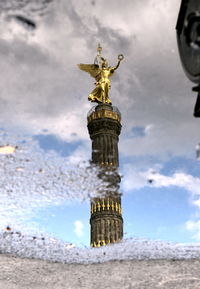 Low angle view of statue against cloudy sky