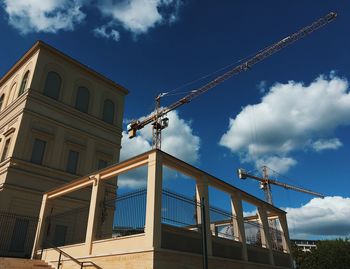 Low angle view of building against cloudy sky