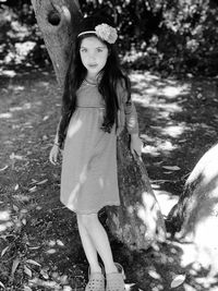 Portrait of girl standing against tree