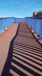 Shadow of railing on footpath