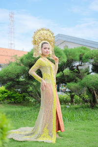 Portrait of young woman standing on field