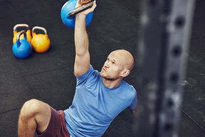 Man training in gym with kettlebell