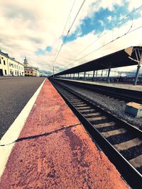 Surface level of railroad station platform against sky