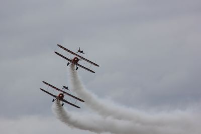 Low angle view of airplane flying in sky