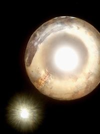 Low angle view of illuminated lights against sky at night