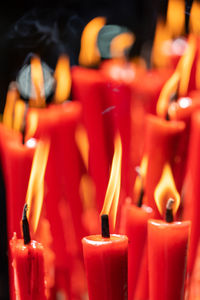 Close-up of lit candles in temple